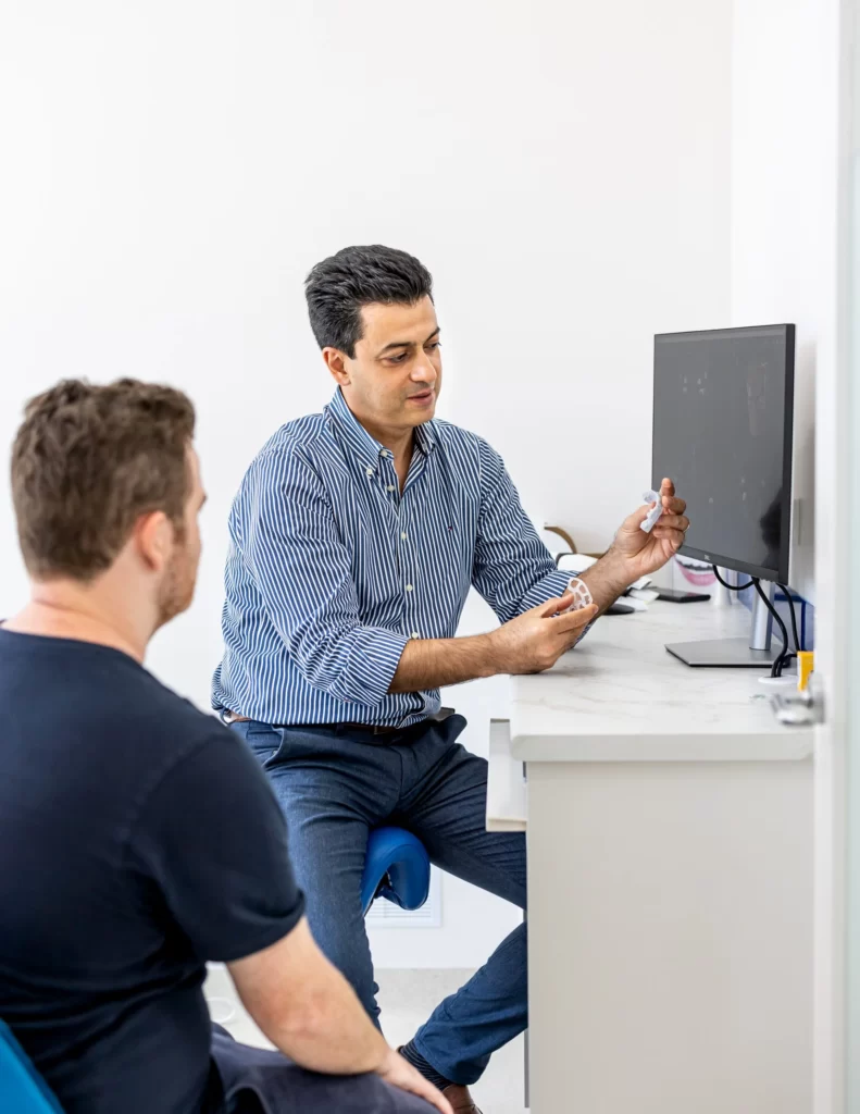 Dentist consulting with client