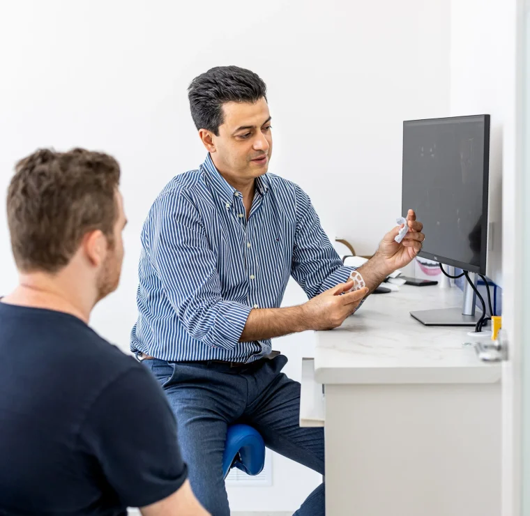 Dentist consulting with client